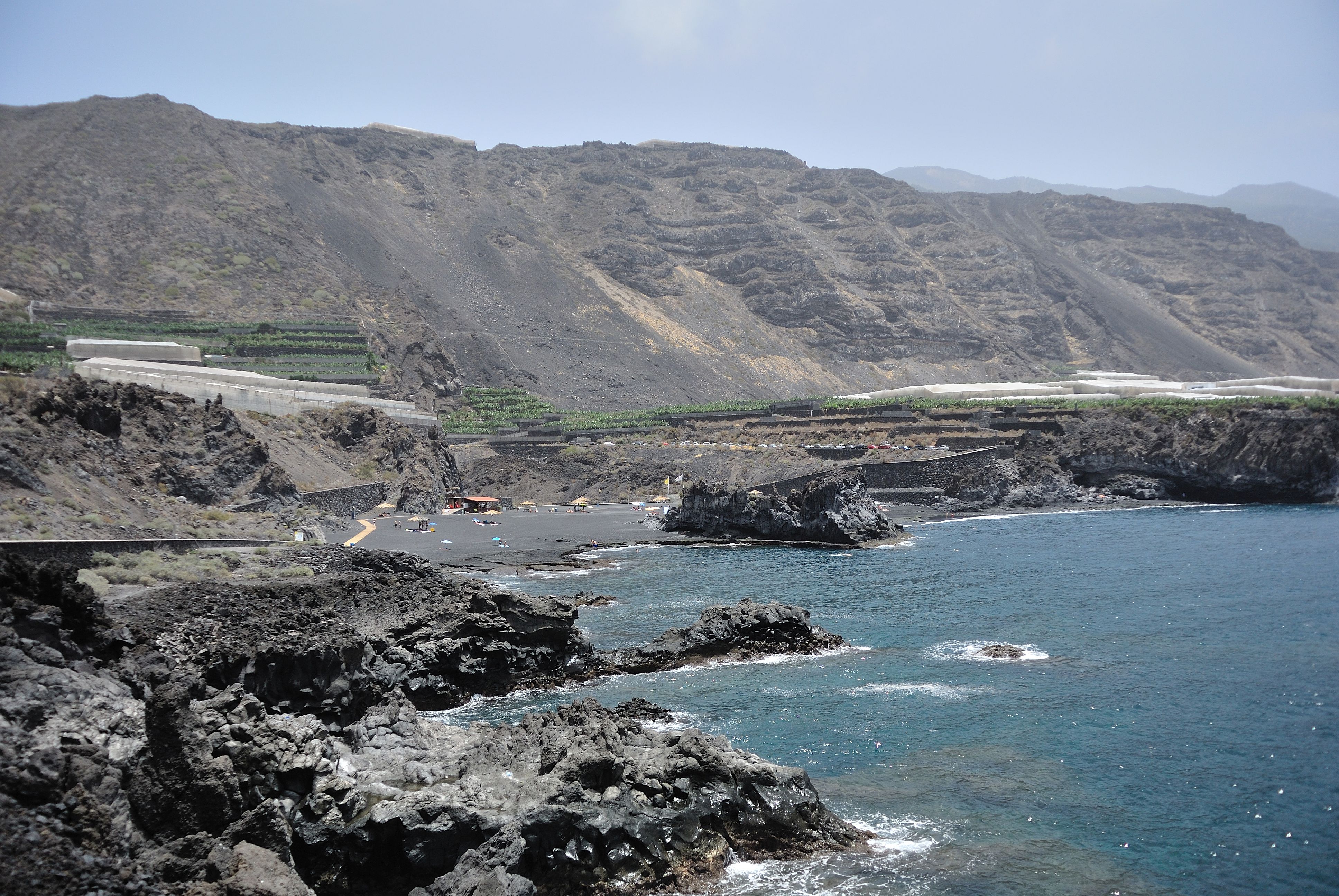 Charco Verde beach in La Palma, featuring a sandy shoreline with calm water conditions