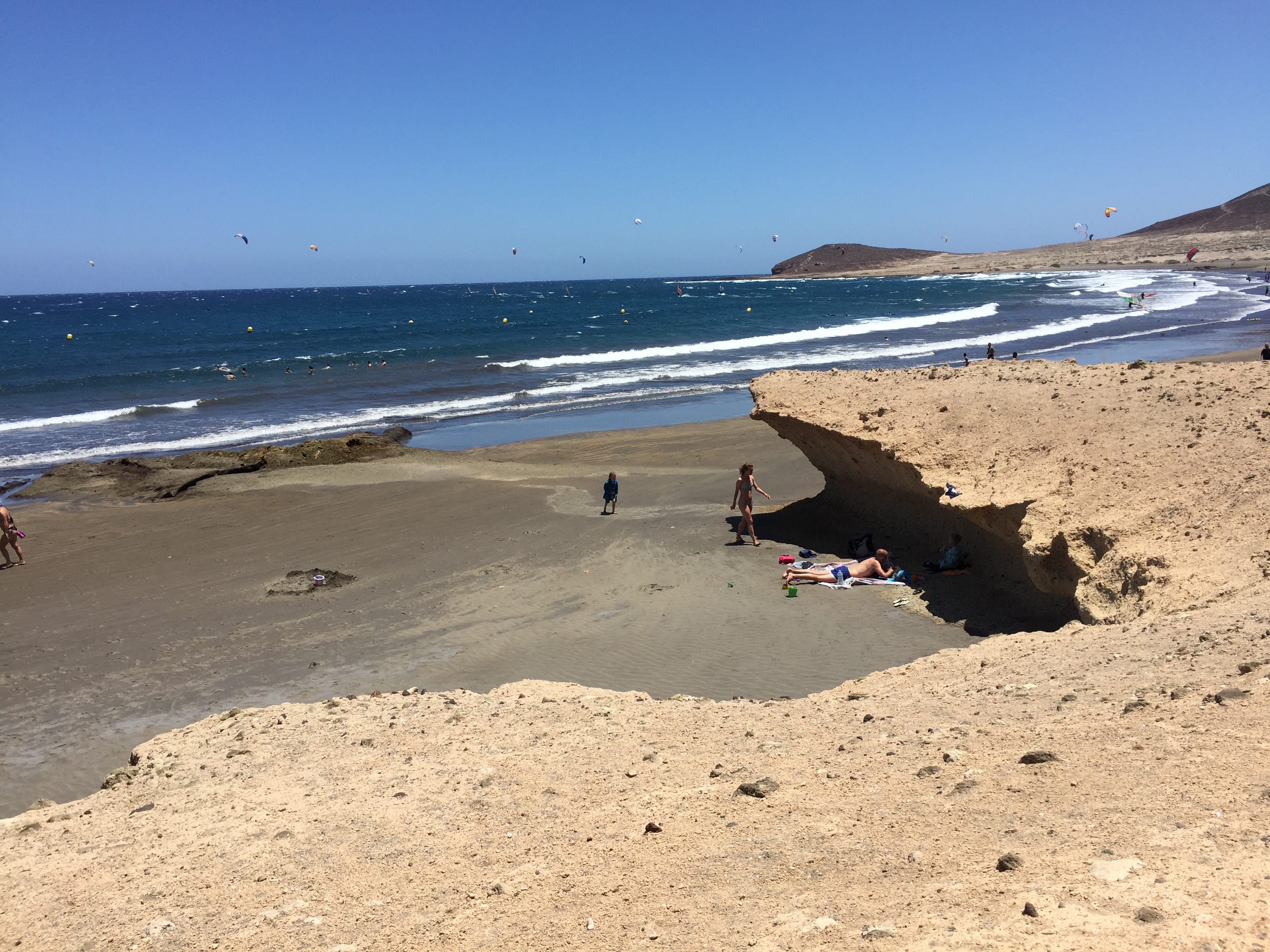 Playa de El Médano beach in Tenerife, featuring a sandy shoreline with surfable water conditions