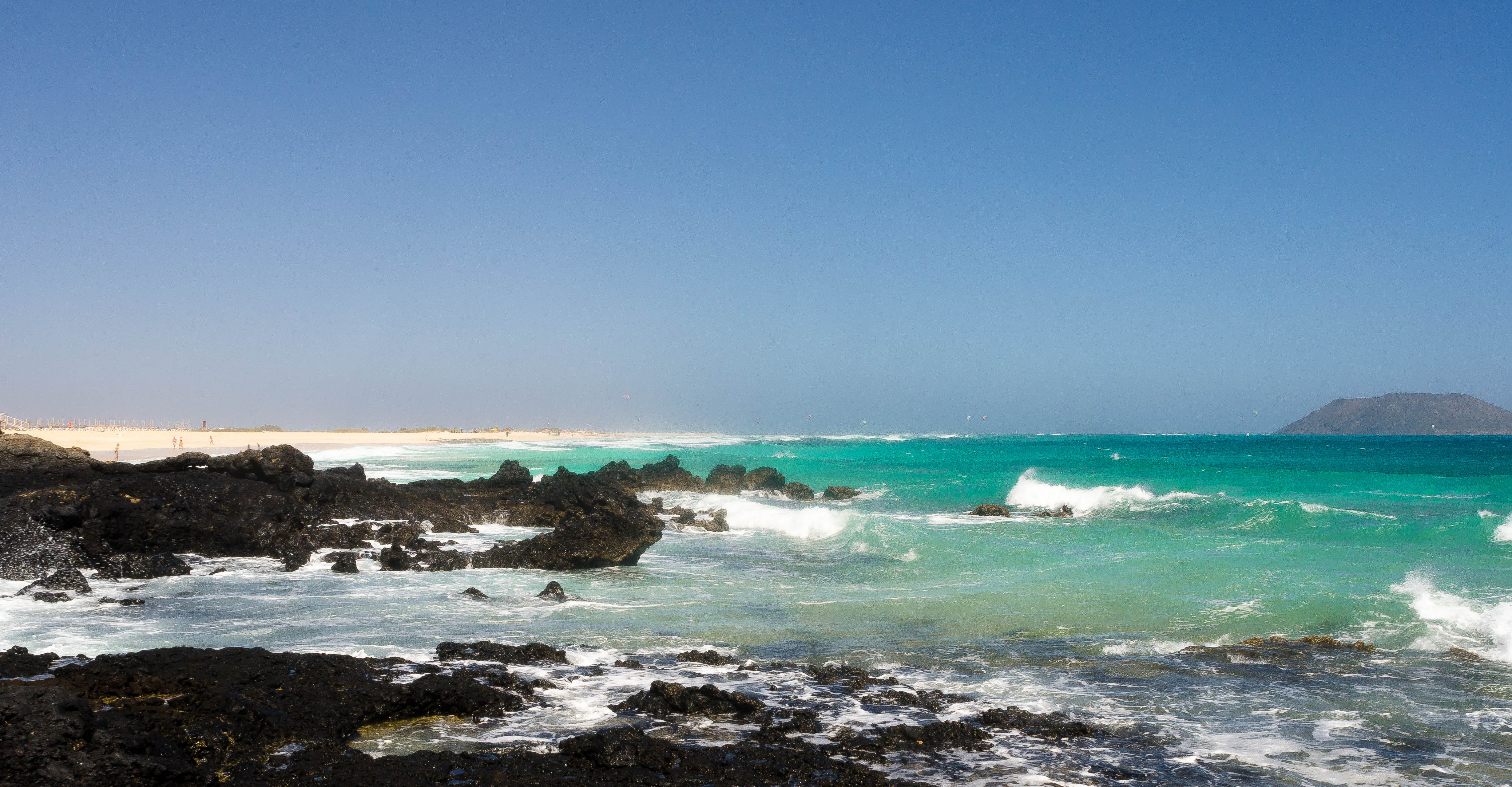 Dunas de Corralejo beach in Fuerteventura, featuring a sandy shoreline with surfable water conditions